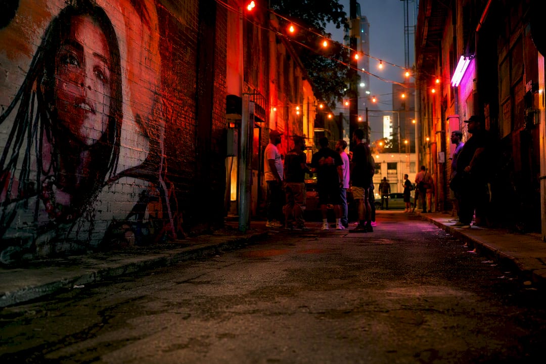 Fictional urban street with NPC character silhouettes