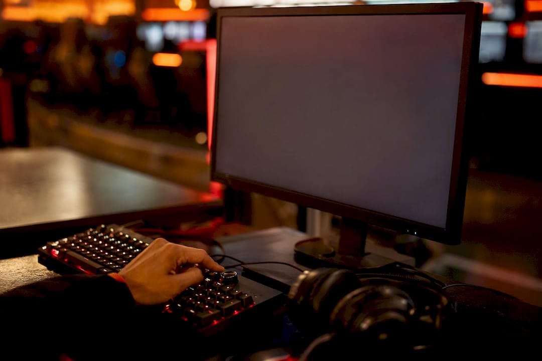 Gamer adjusting headset with subtitles on screen